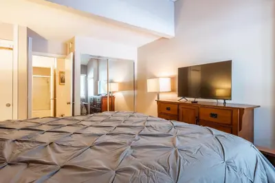 a bedroom with a bed and a flat screen tv at New Listing 2 bedroom and Loft 2 bath Summit E Bldg 16 condo sleeps 8 Steps to Eagle Lodge Chair 15 in Mammoth Lakes