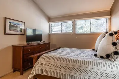 a bedroom with a bed and a flat screen tv at New Listing 2 bedroom and Loft 2 bath Summit E Bldg 16 condo sleeps 8 Steps to Eagle Lodge Chair 15 in Mammoth Lakes