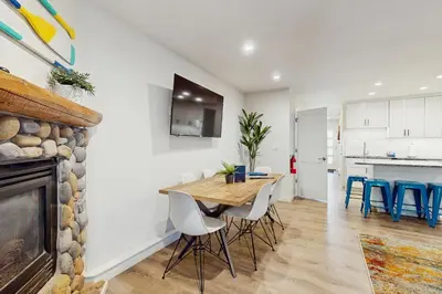 a dining room with a table and chairs and a fireplace at Peace Among the Pines in Incline Village