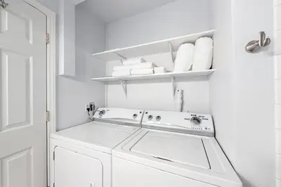 a white laundry room with a washer and dryer at North Tahoe Nest in Incline Village
