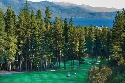 a view of a golf course with trees and water at North Tahoe Nest in Incline Village