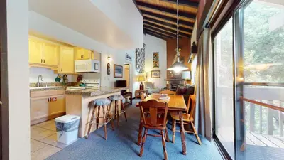 a kitchen and dining room with a table and chairs at La Vista Blanc #44 condo in Mammoth Lakes