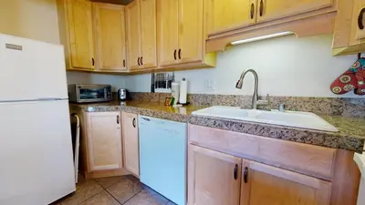 a kitchen with a sink and a white refrigerator at La Vista Blanc #44 condo in Mammoth Lakes