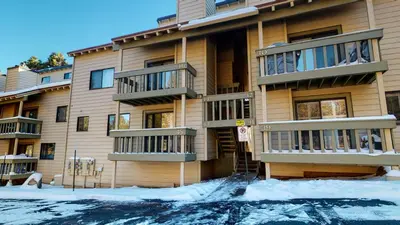 an apartment building with snow in front of it at La Vista Blanc #44 condo in Mammoth Lakes