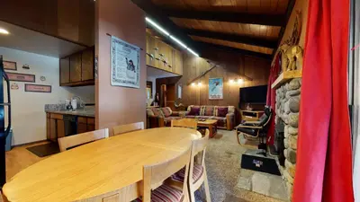 a dining room with a wooden table and chairs at Horizons 4 #186 condo in Mammoth Lakes
