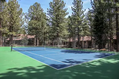 a tennis court with trees in the background at Horizons 4 #186 condo in Mammoth Lakes