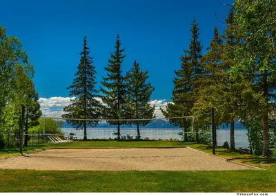 a volleyball net in a park next to a lake at Franciscan Lodge in Tahoe Vista