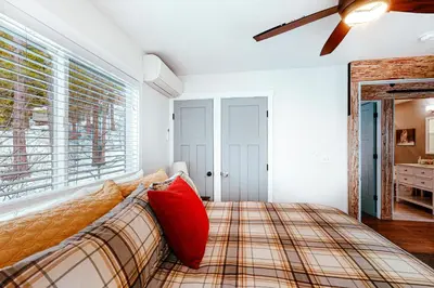 a bedroom with a bed and a ceiling fan at Starfall in Yosemite West