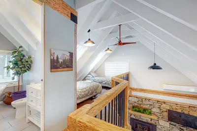 a attic bedroom with a bed and a staircase at Starfall in Yosemite West