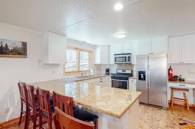 a kitchen with a counter top and a refrigerator at Oso Lodge Unit B in Yosemite West