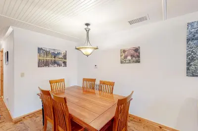 a dining room with a wooden table and chairs at Oso Lodge Unit B in Yosemite West