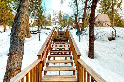 a wooden boardwalk in the snow next to trees at Forest Glen in Yosemite West