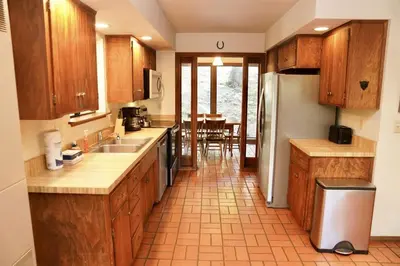 a kitchen with wooden cabinets and a counter top at Forest Glen in Yosemite West