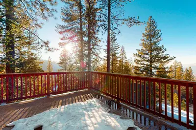 a wooden deck with snow on the ground at Glacier Peak Lodge in Yosemite West
