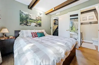 a bedroom with a large bed and a staircase at Chief Peak in Fish Camp