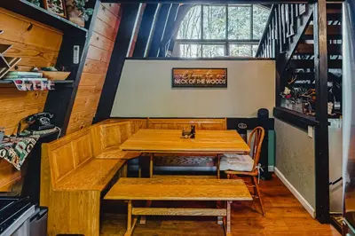 a dining room with wooden tables and chairs at Chief Peak in Fish Camp