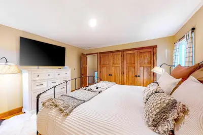 a bedroom with a bed with a flat screen tv at A River Runs Through It in Incline Village