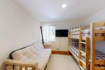 a living room with a couch and bunk beds at A River Runs Through It in Incline Village
