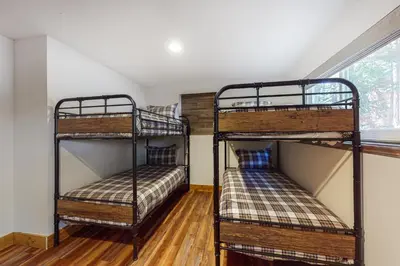 two bunk beds in a room with a window at A River Runs Through It in Incline Village