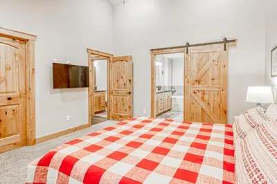 a bedroom with a bed and a flat screen tv at Susquehana Luxury in South Lake Tahoe