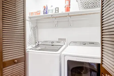 a small laundry room with a washer and dryer at Susquehana Luxury in South Lake Tahoe