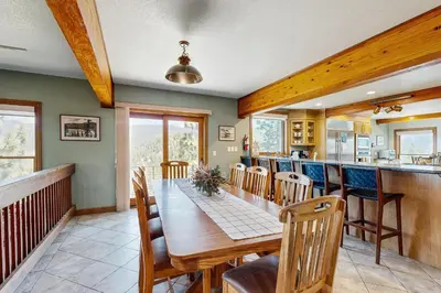 a dining room with a table and a kitchen at Lookout Lodge in Zephyr Cove