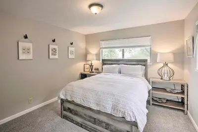 a bedroom with a large bed and a window at Forest-View Deck and Fire Pits Pine Grove Retreat! in Jackson