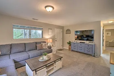 a living room with a couch and a tv at Forest-View Deck and Fire Pits Pine Grove Retreat! in Jackson