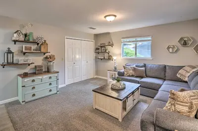 a living room with a couch and a coffee table at Forest-View Deck and Fire Pits Pine Grove Retreat! in Jackson