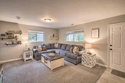 a living room with a couch and a table at Forest-View Deck and Fire Pits Pine Grove Retreat! in Jackson