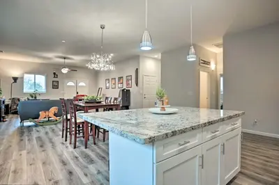 a kitchen and dining room with a large island in the middle at Stunning Clovis Home about 1 Mile to Old Town! in Clovis