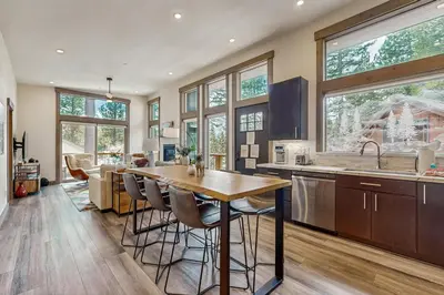 a kitchen with a table and some chairs in a room at Bear's Den in Truckee