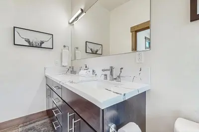 a bathroom with two sinks and a mirror at Bear's Den in Truckee