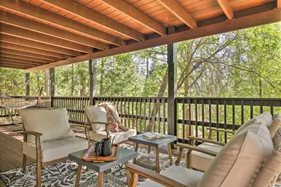 a screened in porch with chairs and a table at Near Trails Cabin with 2-Level Deck in Twain Harte in Twain Harte