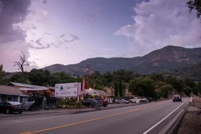 a street in a town with mountains in the background at Genas's Sierra Inn & Restaurant in Dunlap