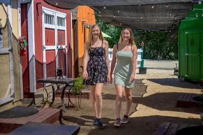 two women are standing in front of a building at Genas's Sierra Inn & Restaurant in Dunlap