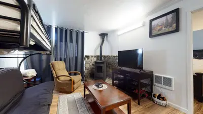 a living room with a couch and a tv at Krystal Villas East #312 condo in Mammoth Lakes