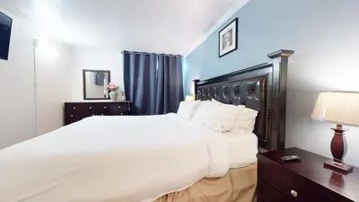 a bedroom with a large white bed and blue walls at Krystal Villas East #312 condo in Mammoth Lakes