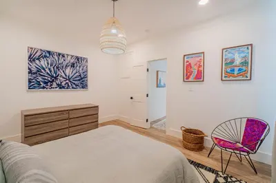 a bedroom with a bed and a chair at Plush 2-bed apt in Riverside Heights! in Reno