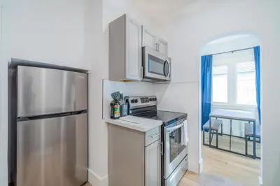 a kitchen with a stainless steel refrigerator and a window at Plush 2-bed apt in Riverside Heights! in Reno