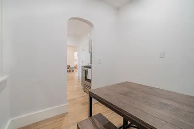 a dining room with a table and a kitchen at Plush 2-bed apt in Riverside Heights! in Reno