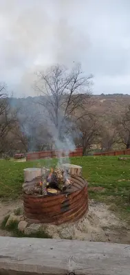 a fire pit in a field with smoke at Sequoia Resort in Badger