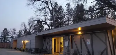 a building with tables and chairs outside of it at Sequoia Resort in Badger
