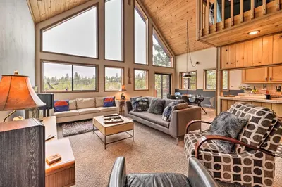 a living room filled with furniture and windows at Deck and Fireplace Log Cabin in Tahoe Donner! in Truckee