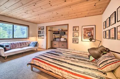 a bedroom with a bed and a couch at Deck and Fireplace Log Cabin in Tahoe Donner! in Truckee