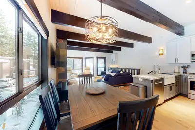 a kitchen and living room with a dining room table at Maison de Montagne in Incline Village
