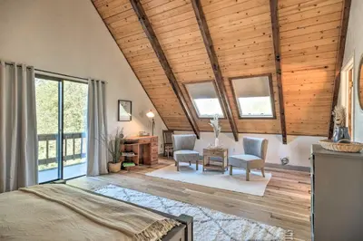 a bedroom with a bed and a desk and chairs at Modern Groveland Chalet about 25 Mi to Yosemite! in Groveland