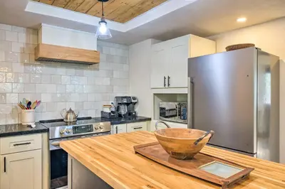 a kitchen with a wooden counter top with a refrigerator at Modern Groveland Chalet about 25 Mi to Yosemite! in Groveland