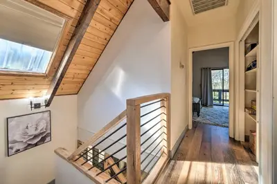 a staircase in a house with a wooden ceiling at Modern Groveland Chalet about 25 Mi to Yosemite! in Groveland