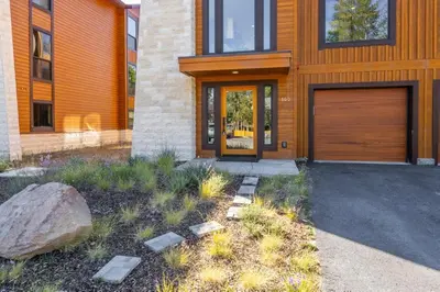 a house with a wooden door and a rock at Obsidian 300 in Mammoth Lakes